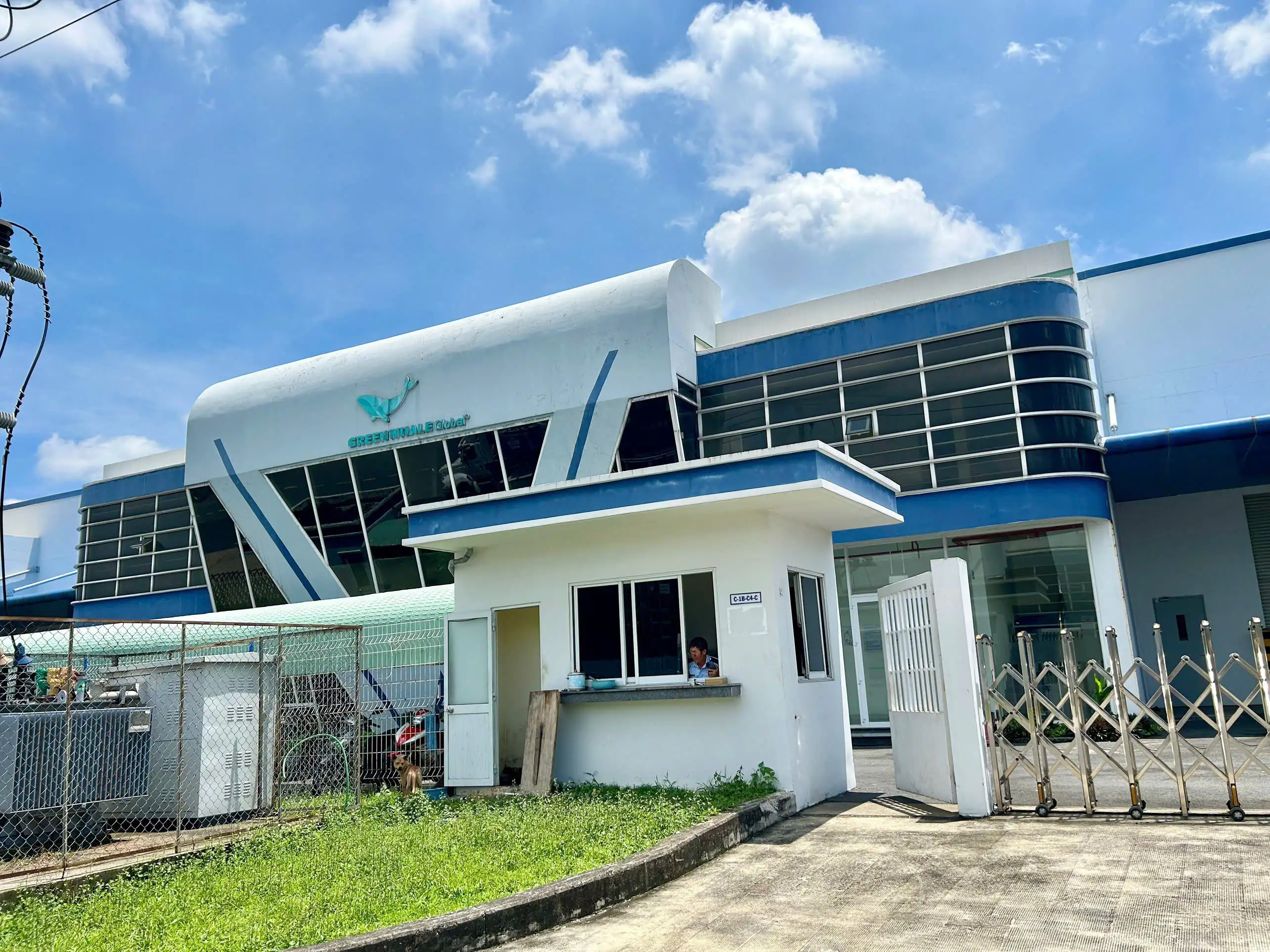 A building with a gate and grassAI-generated content may be incorrect.